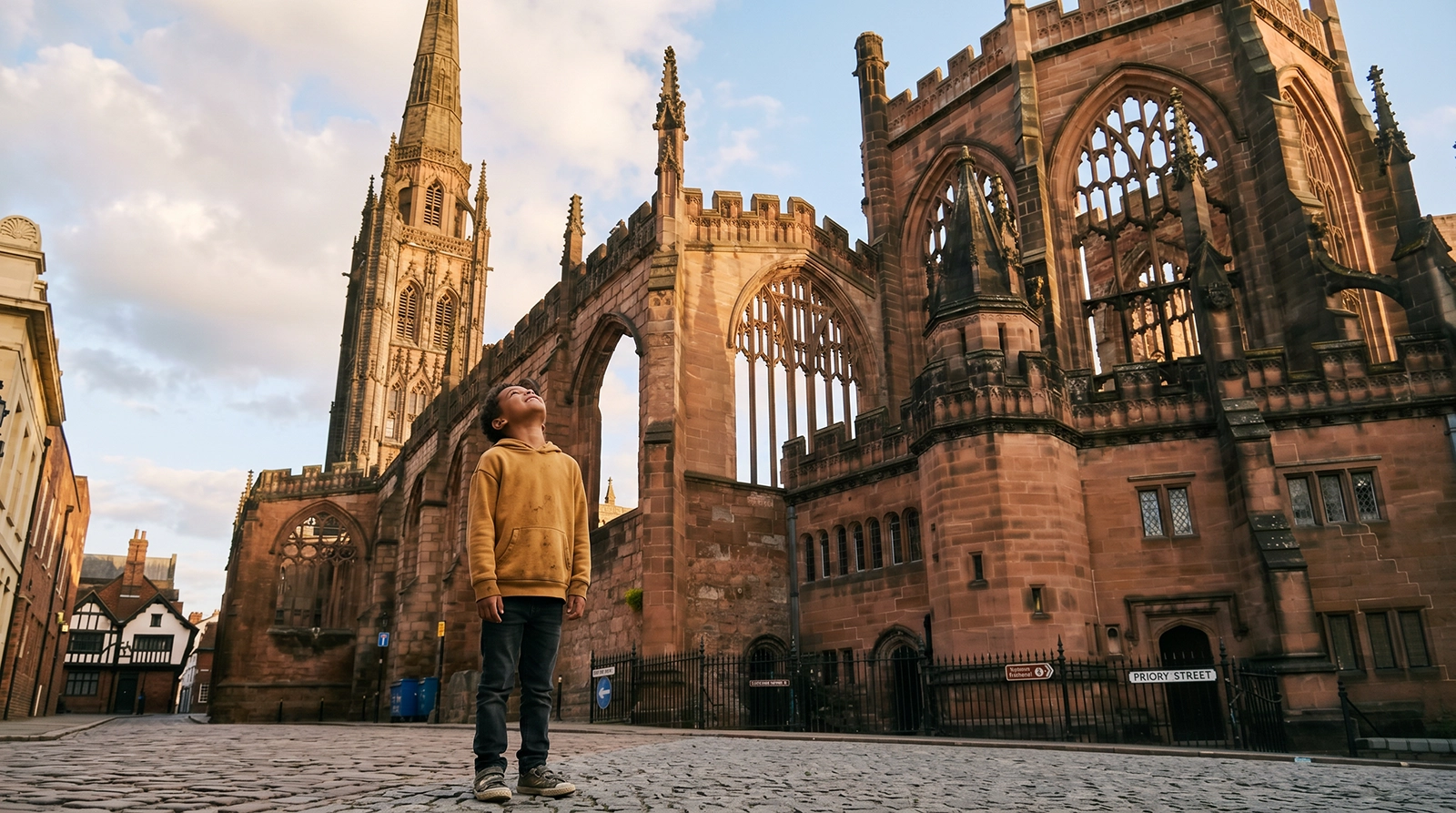 Young boy exploring the ruins of Coventry Cathedral, part of the wider West Midlands region
